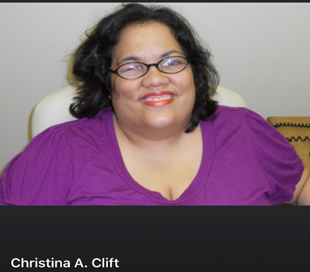Photo of Christina Clift, a woman with ar darker complexion, and dark shoulder length hair. She is wearing dark rimmed glasses and a short sleeve purple top while smiling at the camera.