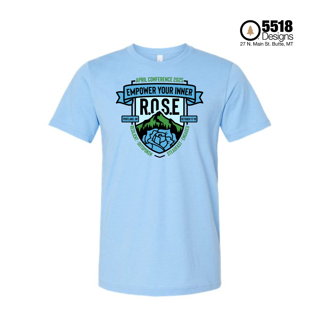 APRIL 2025 Conference t-shirt. A blue shirt with a shield in blue and green color scheme that shows the Oregon mountainscape and a rose. Above this is text that says "APRIL Conference 2025. Empower Your Inner R.O.S.E."