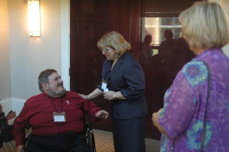 Man in chair and lady in a discussion