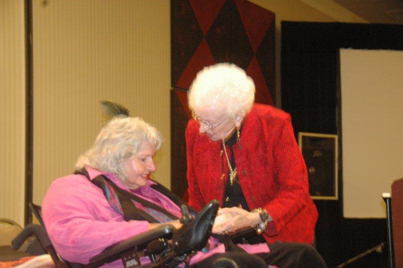 Linda Gonzales receives Earl Walden Award from Betty Walden