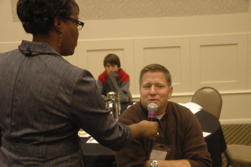 lady and man with man sharing into mic