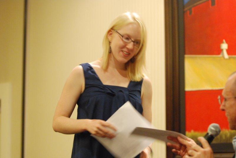 Lady taking a piece of paper from a man