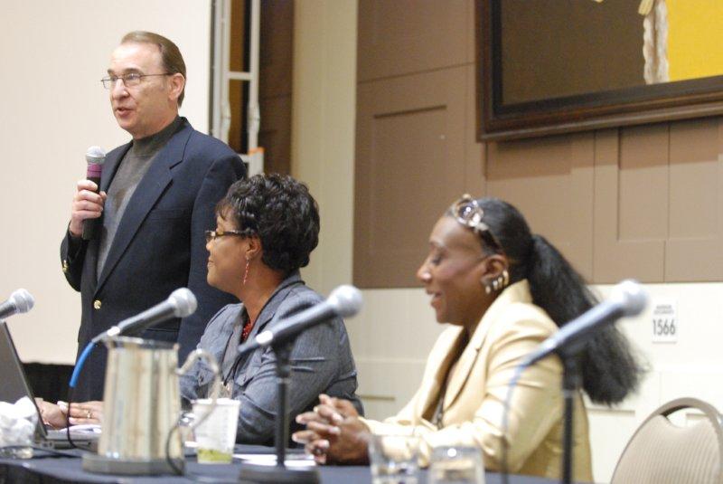 man and two ladies speaking to a group
